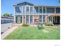 Updated townhome exterior, featuring a well-maintained lawn and landscaping at 11761 E Canal Dr, Aurora, CO 80011