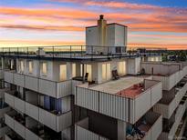 An aerial view of a multi-level building with balconies and rooftop decks at 1313 Steele St # 801, Denver, CO 80206