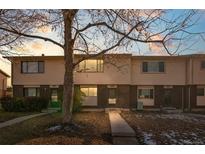 Three-unit townhouse building exterior, showcasing a well-maintained front yard and walkway at 1290 S Troy St, Aurora, CO 80012