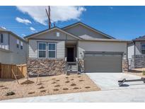 Ranch style home with a two-car garage and nicely landscaped front yard at 1837 Water Birch Way, Castle Rock, CO 80108