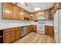 Bright kitchen with light wood cabinets and appliances at 660 S Alton Way # 5C, Denver, CO 80247