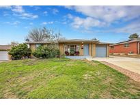Ranch style home with attached garage and landscaped yard at 7131 Clay St, Westminster, CO 80030