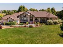 Ranch-style home on a spacious lot with mature landscaping and a large yard at 385 Baxter Farm Ln, Erie, CO 80516