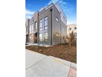Modern three-story townhome with metal siding and landscaping at 5870 W 91St Ave, Westminster, CO 80031