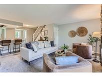 Bright living room with comfy seating, a fireplace, and access to a patio at 1649 S Ivory Cir # D, Aurora, CO 80017