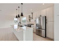 Modern kitchen with stainless steel appliances and large island at 10151 W 38Th Ave, Wheat Ridge, CO 80033