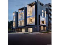 Three modern townhouses at night, showcasing a contemporary design and sleek architecture at 2556 18Th St, Denver, CO 80211