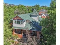 Aerial view of charming home with mountain backdrop at 1843 Spruce St, Boulder, CO 80302