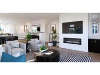 Modern living room with a fireplace and plenty of natural light at 3833 Whispering Sage St, Evergreen, CO 80439