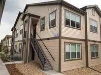 Tan two-story building with dark brown accents and stairs leading to the entrance at 4630 Copeland Cir # 102, Highlands Ranch, CO 80126