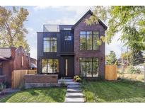 Modern two-story brick house with a metal roof and large windows at 3362 W 32Nd Ave, Denver, CO 80211