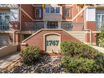 Brick building exterior with landscaping and address number 1747 at 1747 N Washington St # C306, Denver, CO 80203