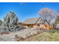 Brick ranch house with attached garage and landscaped front yard at 1627 E Jamison Pl, Centennial, CO 80122