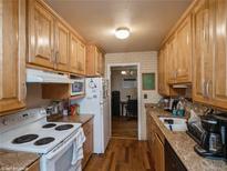 Eat-in kitchen with wood cabinets and hardwood floors at 300 S Simms St, Lakewood, CO 80228