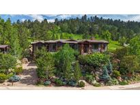 Mountain view home with stonework landscaping and large windows at 1420 Sierra Dr, Boulder, CO 80302