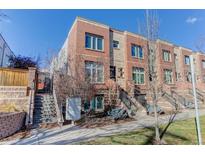 Attractive three-story townhome with brick exterior and landscaping at 2311 Decatur St, Denver, CO 80211