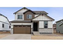 Two-story home with brown accents and a two-car garage at 16870 Mckay Dr, Mead, CO 80542