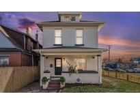 Charming two-story home with a well-manicured front yard at 300 Inca St, Denver, CO 80223
