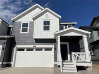 Two-story Craftsman home with gray siding and white accents at 1309 Sunrise Dr, Erie, CO 80516