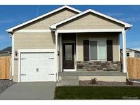 New ranch-style home with a white garage door and stone accents at 5863 Sawdust Dr, Brighton, CO 80601