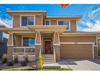 Two-story Craftsman style home with brick and siding at 8340 Gardenia St, Arvada, CO 80005