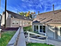 Complex of tan-colored buildings with a landscaped courtyard at 371 S Estes St # 10, Lakewood, CO 80226