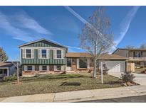 Brick ranch home with green accents and a spacious yard at 9552 Field Ct, Broomfield, CO 80021