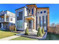 Modern two-story home with brick and light-colored siding, landscaping, and a walkway at 2544 Chase St, Edgewater, CO 80214