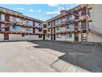 Aerial showing the apartment building and its parking lot at 590 N Logan St # 210, Denver, CO 80203