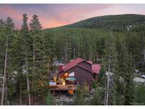 Mountain home with deck and hot tub at sunset at 153 Regal Cir, Breckenridge, CO 80424