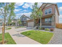 Houses with similar architectural styles and well-maintained landscaping at 954 Plum Creek Ct, Brighton, CO 80601