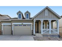 Two-story craftsman style home with front porch and two-car garage at 1090 Sunrise Dr, Erie, CO 80516