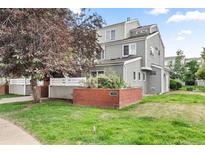 Exterior view of townhome with landscaping and brick wall at 3103 29Th St # 103, Boulder, CO 80301