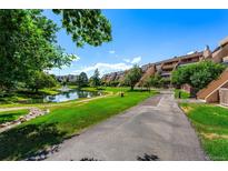Landscaped grounds with pond and walking path near condo building at 7000 E Quincy Ave # 204, Denver, CO 80237