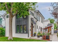 Modern two-story home with gray and white exterior, and a patio at 1468 S Washington St, Denver, CO 80210