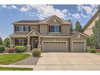 Two story house with three car garage and manicured lawn at 4766 Longs Ct, Broomfield, CO 80023