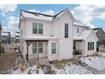 Two-story farmhouse style home with white exterior at 294 Dipper Ct, Berthoud, CO 80513