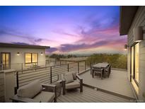 Enjoy sunset views from this rooftop deck with seating and dining areas at 9070 Harlan St, Westminster, CO 80031