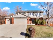 Two-story house with brick and siding, attached two-car garage, and landscaped yard at 11102 Zephyr St, Westminster, CO 80021