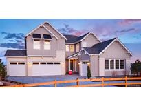 Two-story home with a neutral color palette and attached garage at 16985 Black Rose Pl, Parker, CO 80134