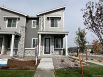 Two-story home with stone and siding exterior at 27497 E Maple Ave, Aurora, CO 80018