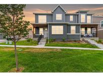 Two-story home with gray siding and landscaping at 317 Gray Jay Ct, Berthoud, CO 80513