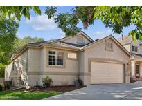 House exterior with a landscaped yard and attached garage at 5095 S Newcombe Ct, Littleton, CO 80127