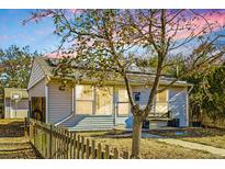 Ranch-style home with solar panels and a fenced yard at 7956 Oneida St, Commerce City, CO 80022