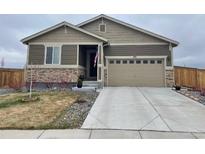Beige ranch home with two-car garage and landscaped yard at 273 S Kewaunee Way, Aurora, CO 80018