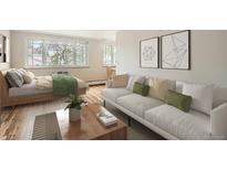 Studio apartment living room with sofa, bed, and wood floors at 969 S Pearl St # 204, Denver, CO 80209