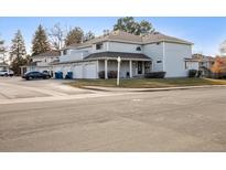 Exterior view of a two-story townhome with attached garage and landscaping at 12602 E Warren Dr # D, Aurora, CO 80014