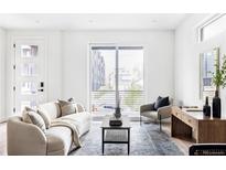 Bright living room with modern furniture and large window offering natural light at 1231 Perry St # 2, Denver, CO 80204