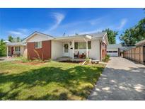 Charming brick ranch home with a front porch and driveway at 4660 S Pennsylvania St, Englewood, CO 80113