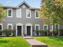 Gray two-story duplex with a well-maintained lawn and walkway at 232 W 5Th Ave, Denver, CO 80204